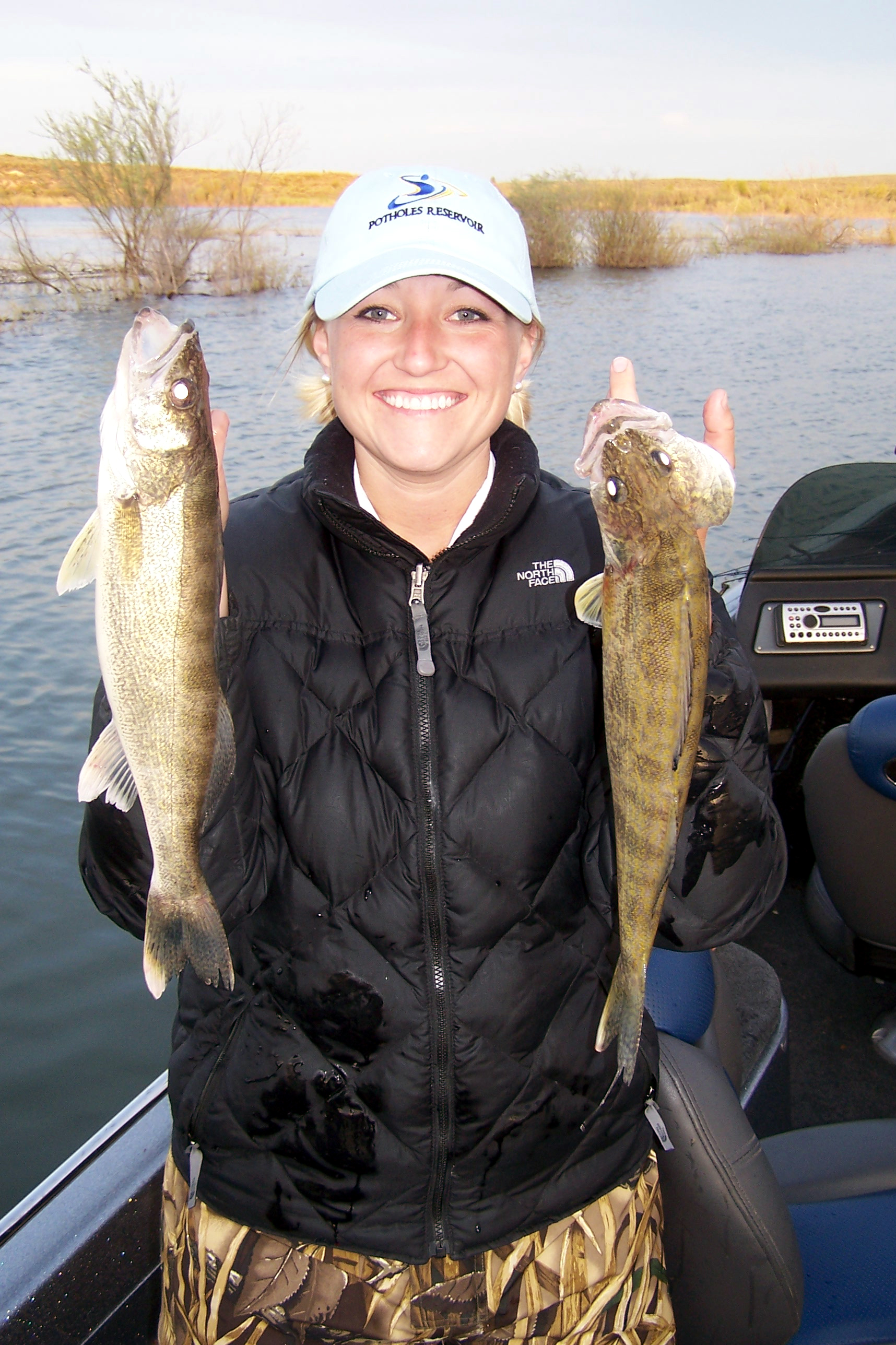Kellee Brown with a pair of keeper walleye she caught on Potholes Reservoir