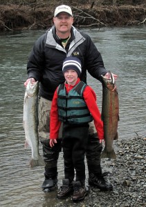 The author, Jason Brooks, with his son Ryan and two winter steelhead on the bank